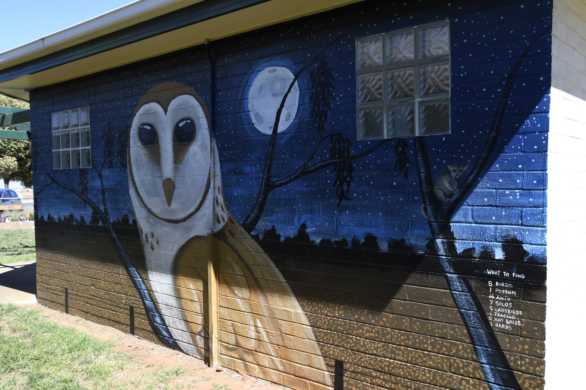 Night scene ... A detail on this panel of the mural challenges you to find a list of items scattered around the four sides of the Katamatite toilet block. 
