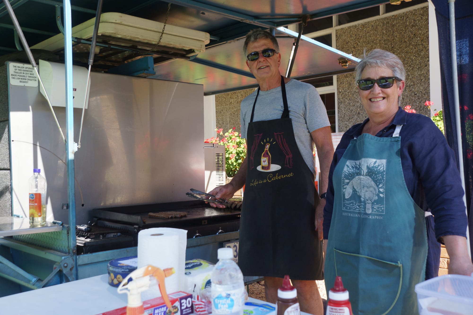 Sizzlin’... Rob and Glenda Elliott cooking snags.