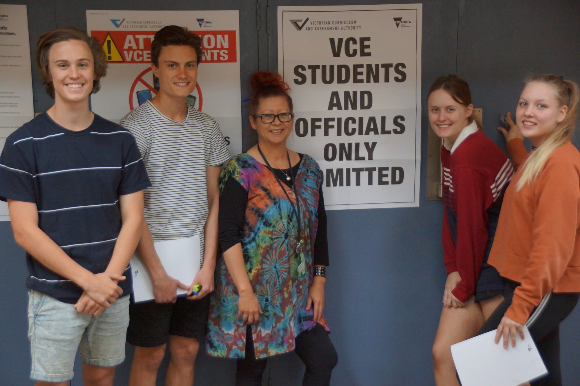 One down ... Students Adam Mansfield, Luke Mansfield, Hayley McKinnon and Teriecha Bowen gather around English teacher Rae Wood, all equally relieved to have the big exam over.