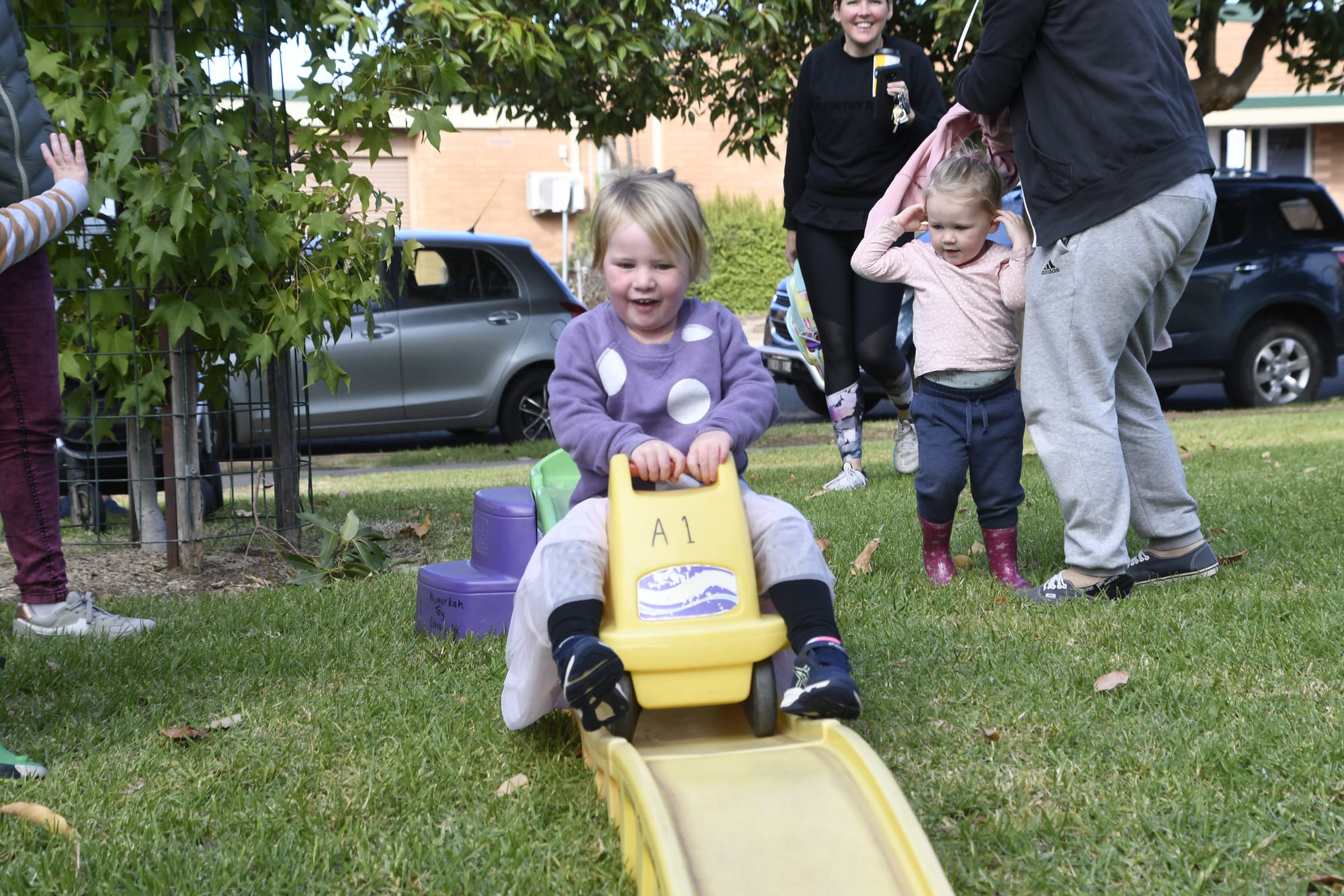 Zoom ... Maisie Stanbrook speeds down the slide on her toy bike. 
