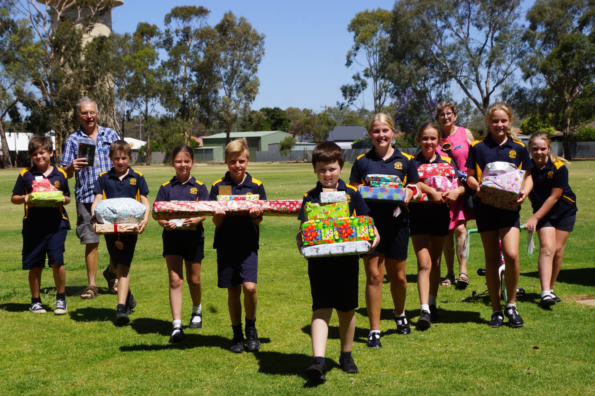 Delivering kindness ... (From left): Curtis McKellar, Pieter Mezenberg from St Vinnies, Alexander Robertson, Claire Rae, Jarred Bethell, Lucas Hendy, Milla Dobson, Laura Bergamin, Francine Mezenberg from St Vinnies, Ashlee Dyson and Rahni Lawless walk gifts donated by the St Joe’s community to the presbytery for sorting. 