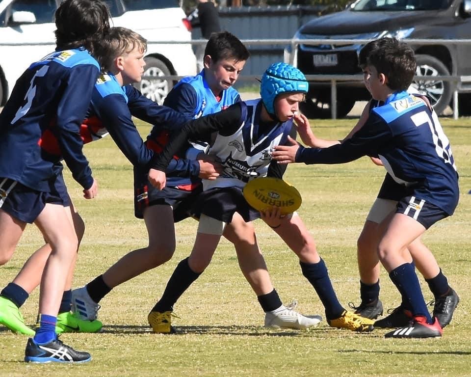 Surrounded ... Jarred Bethall gets a handball away.