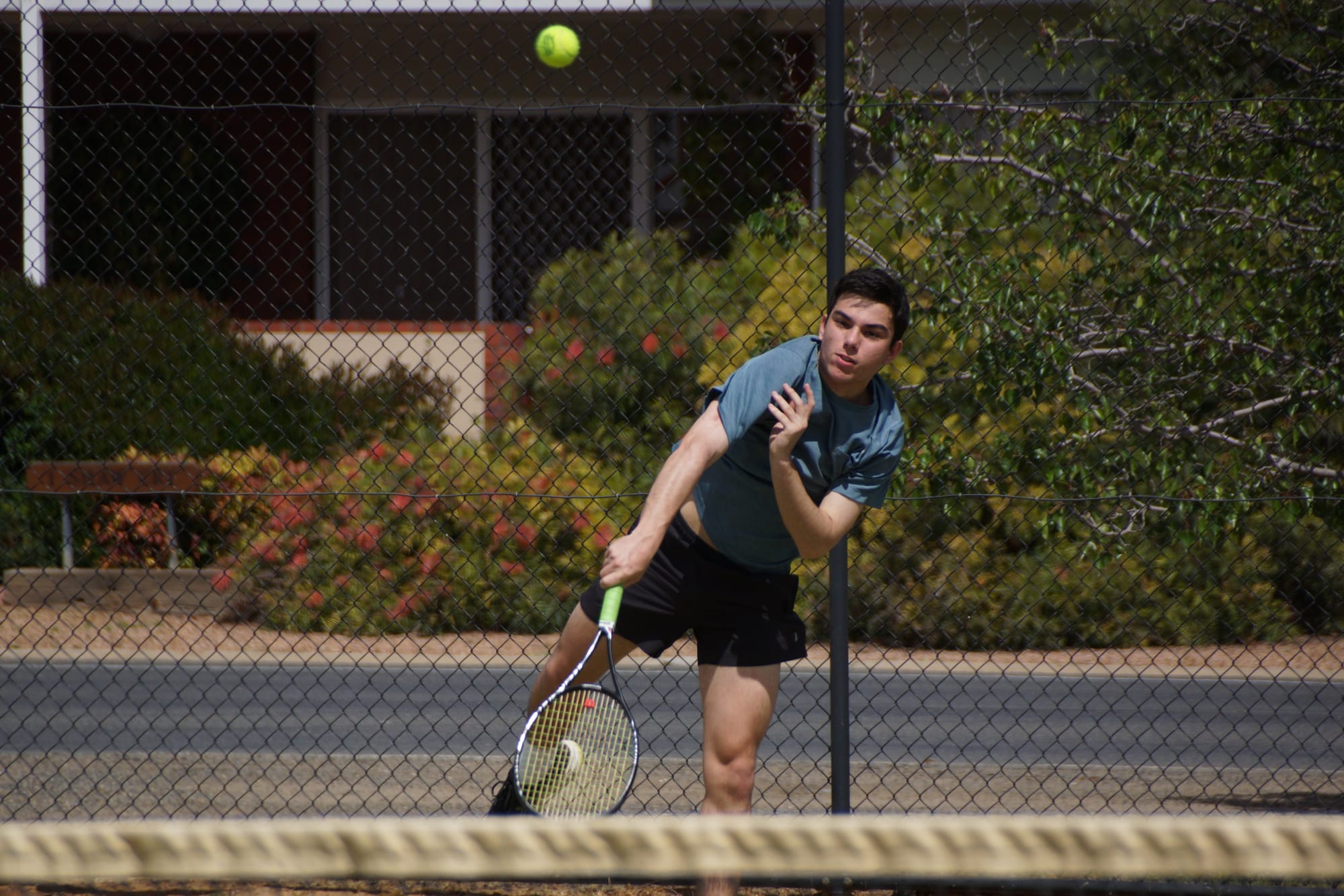 New Penguin ... Michael Kam sends down a serve for the Penguins during the first round of Goulburn Murray tennis on Saturday.