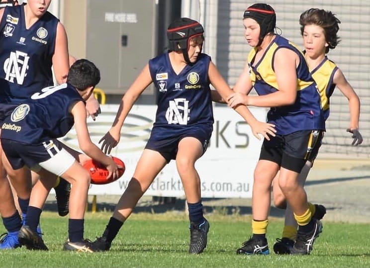 Teamwork ... Arthur Smith shepherds as Ollie Ruscoe gets his hands on the ball. 