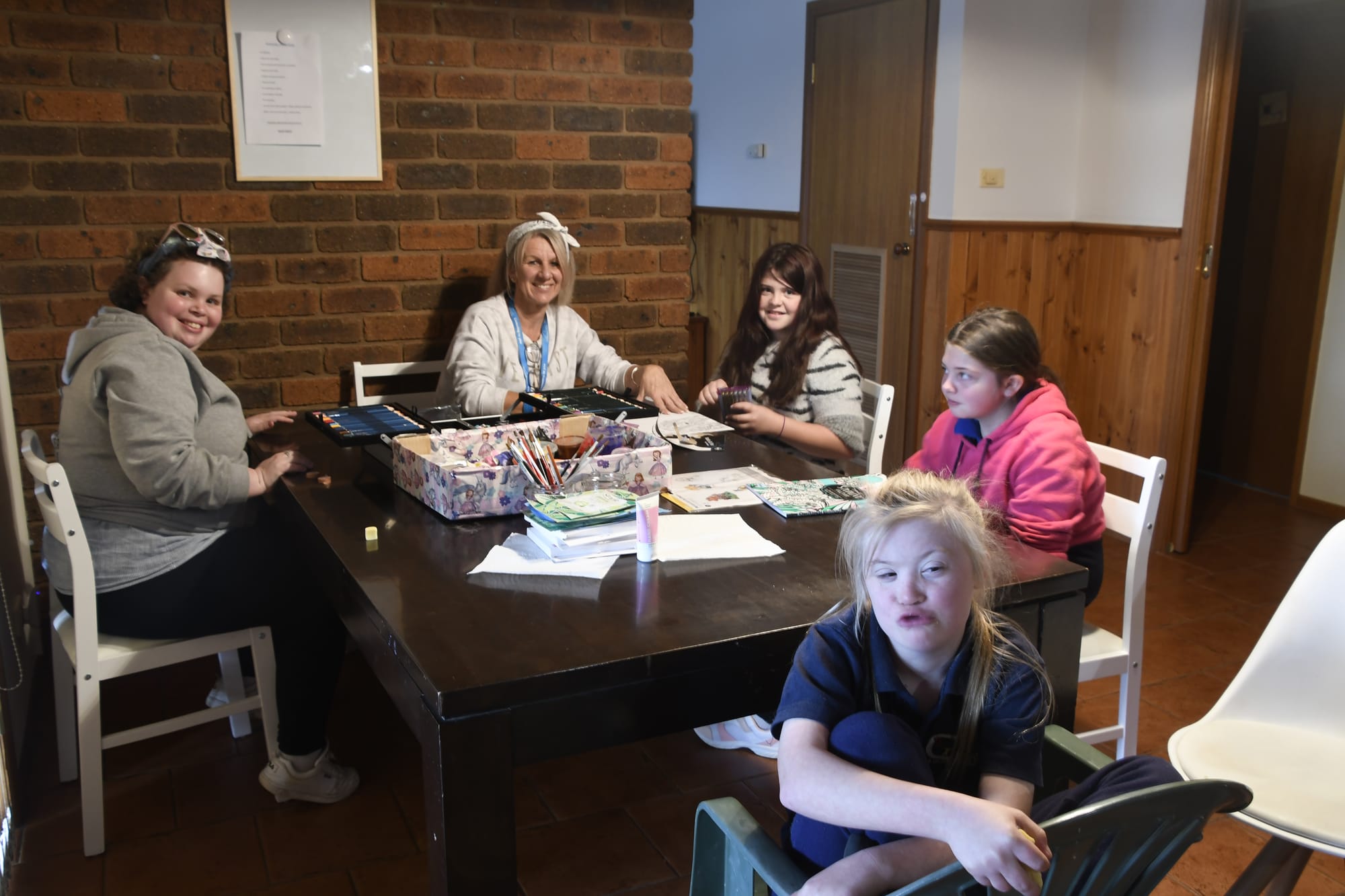Social support... Disability care support worker Deb Pegg (second left) helps girls group participants (from left) Emma Kilpatrick, Georgia Higgins, Hollee Clark and Kelsey Higgins paint their nails ahead of a soothing face mask. 
