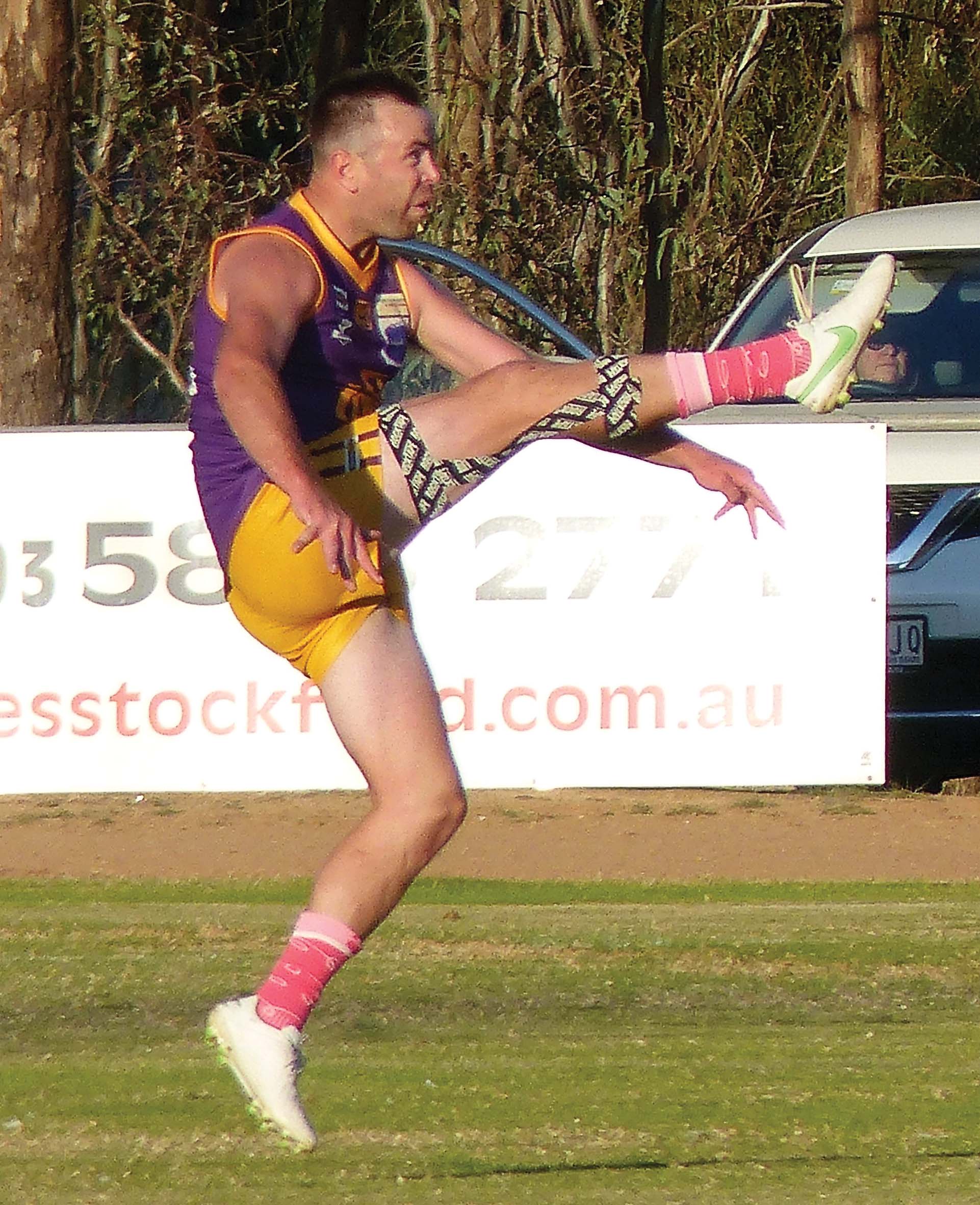 Milestone man ... Brett ‘Bones’ Vallender boots one of five goals in his 200th game. 