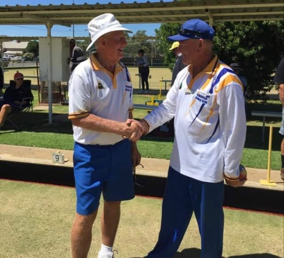 Another feather ... Peter Dealy congratulates Don Staggard on his club championship victory.