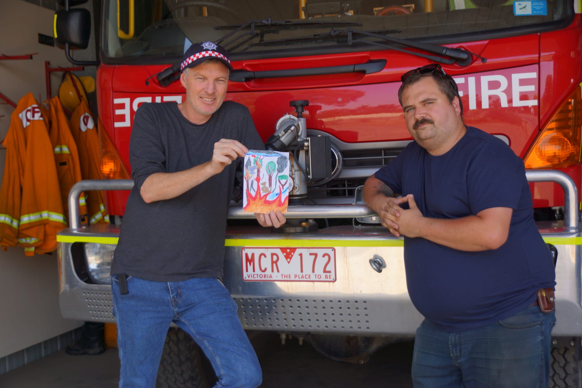 Thank you ... Daniel Watson and Clinton Porter from Wunghnu CFA brigade, with the thank you card Daniel received,  are happy to be home for now. 