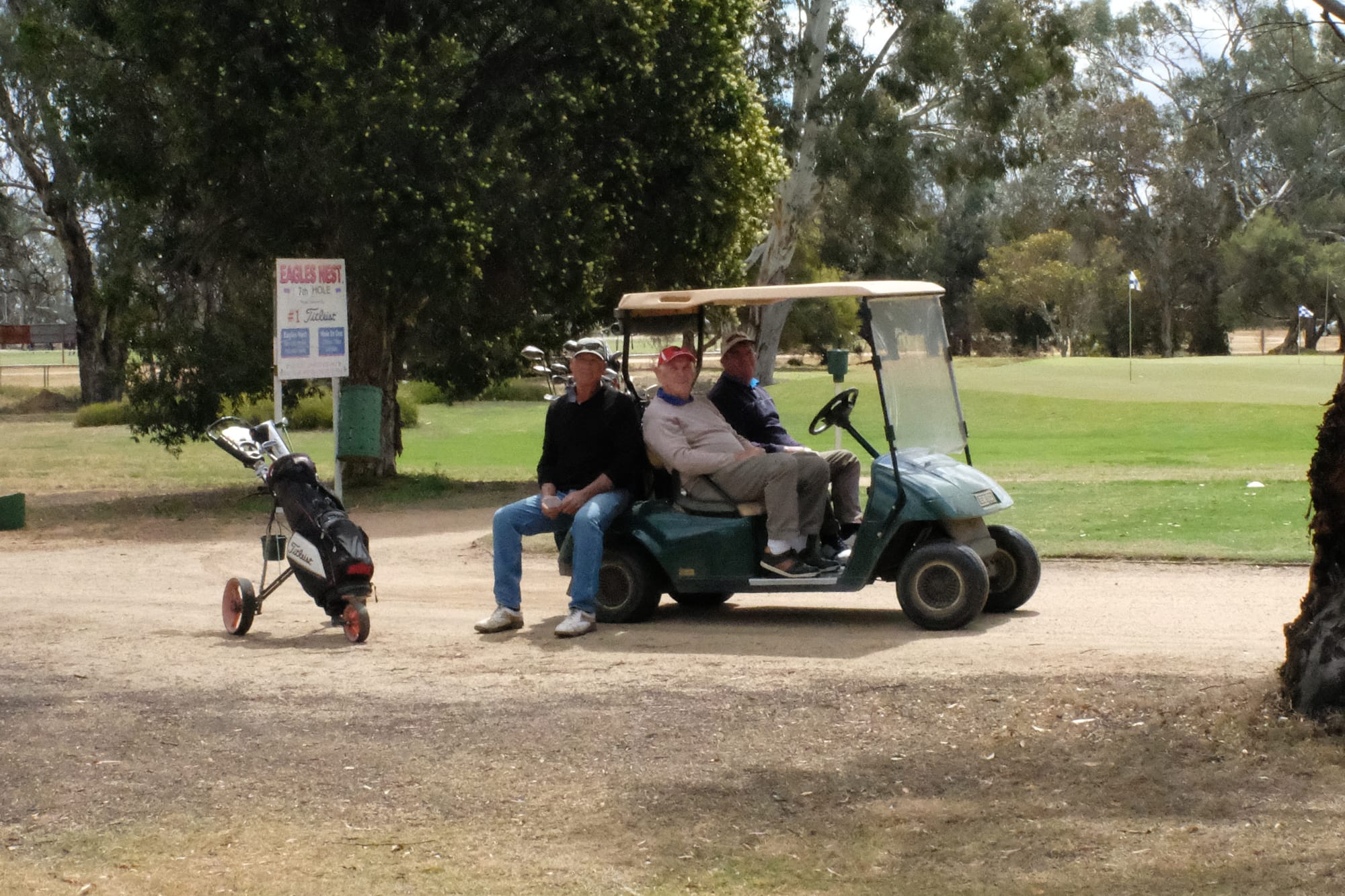 Chillin’ out ... Robbie Sutton, Hughie Gunn and Barry Pruden relax on the seventh tee while waiting for the group in front to clear the par three green.