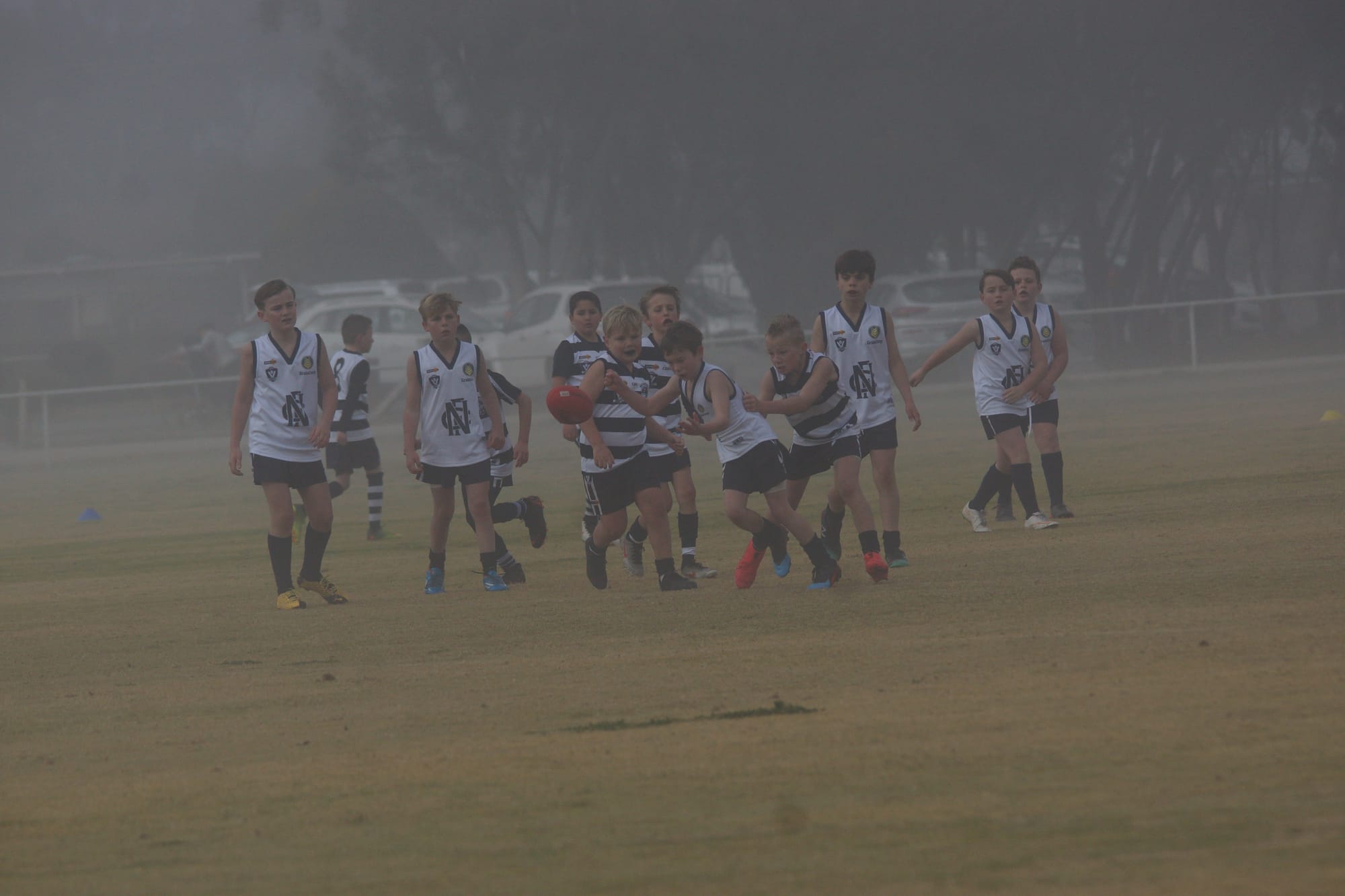 In the nick of time ... Charlie McDonald gets his handball away before being tackled.
