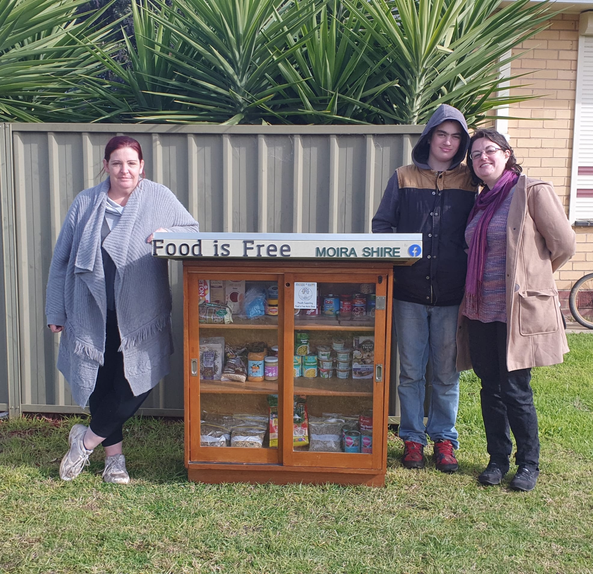 Community effort... (From left): Vicky Fraser with  Kyle Michlemore and Bek Happy at the new and improved pet pantry.
