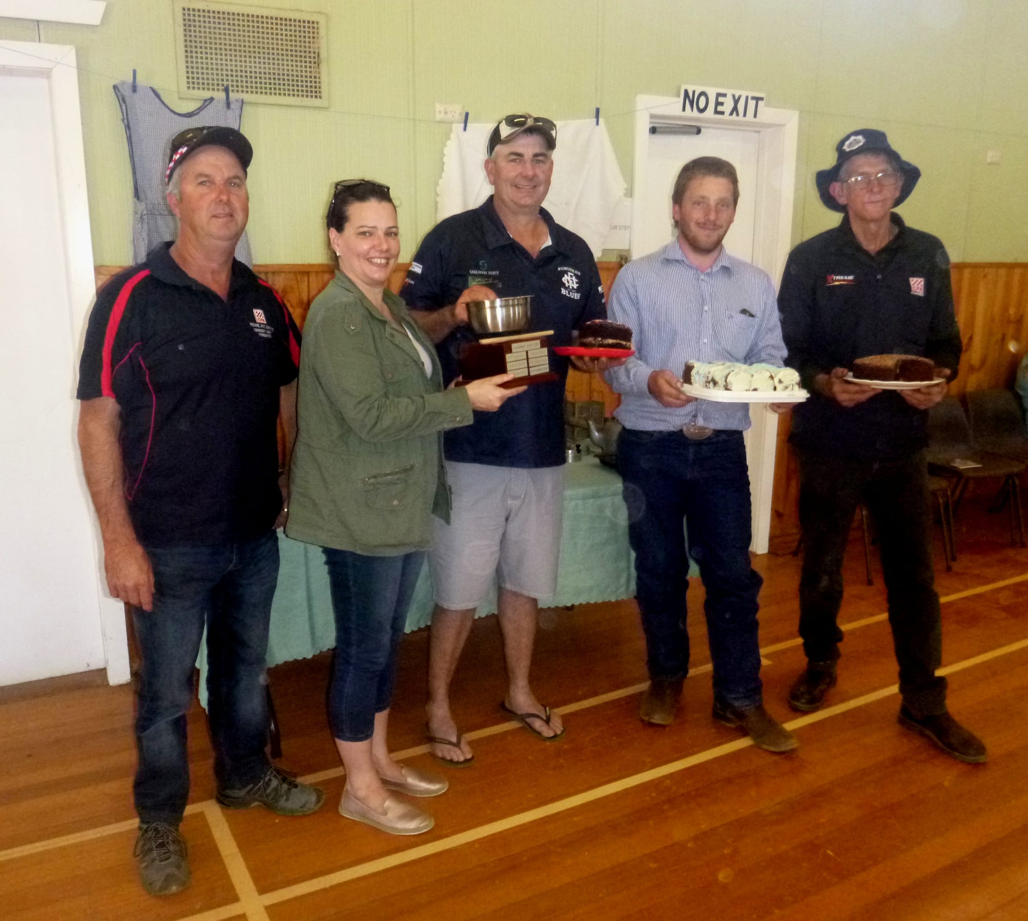 Facial expressions tell the tale ... (From left):  Trevor Carlisle, secure in the knowledge his scones are the best, judge Kiara Brown presenting the perpetual trophy to a happy Graeme Sprunt, Pete Alblas thrilled with an early result, and a sceptical looking Col Grinter. 