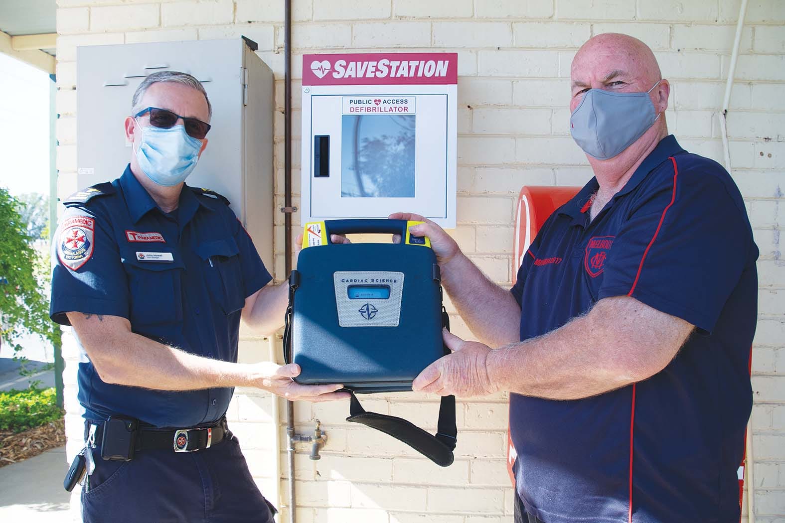 Community asset... Paramedic John Howell and Katunga postmaster Peter Heyen teamed up to ensure that locals  have 24/7 access to an AED machine. 
