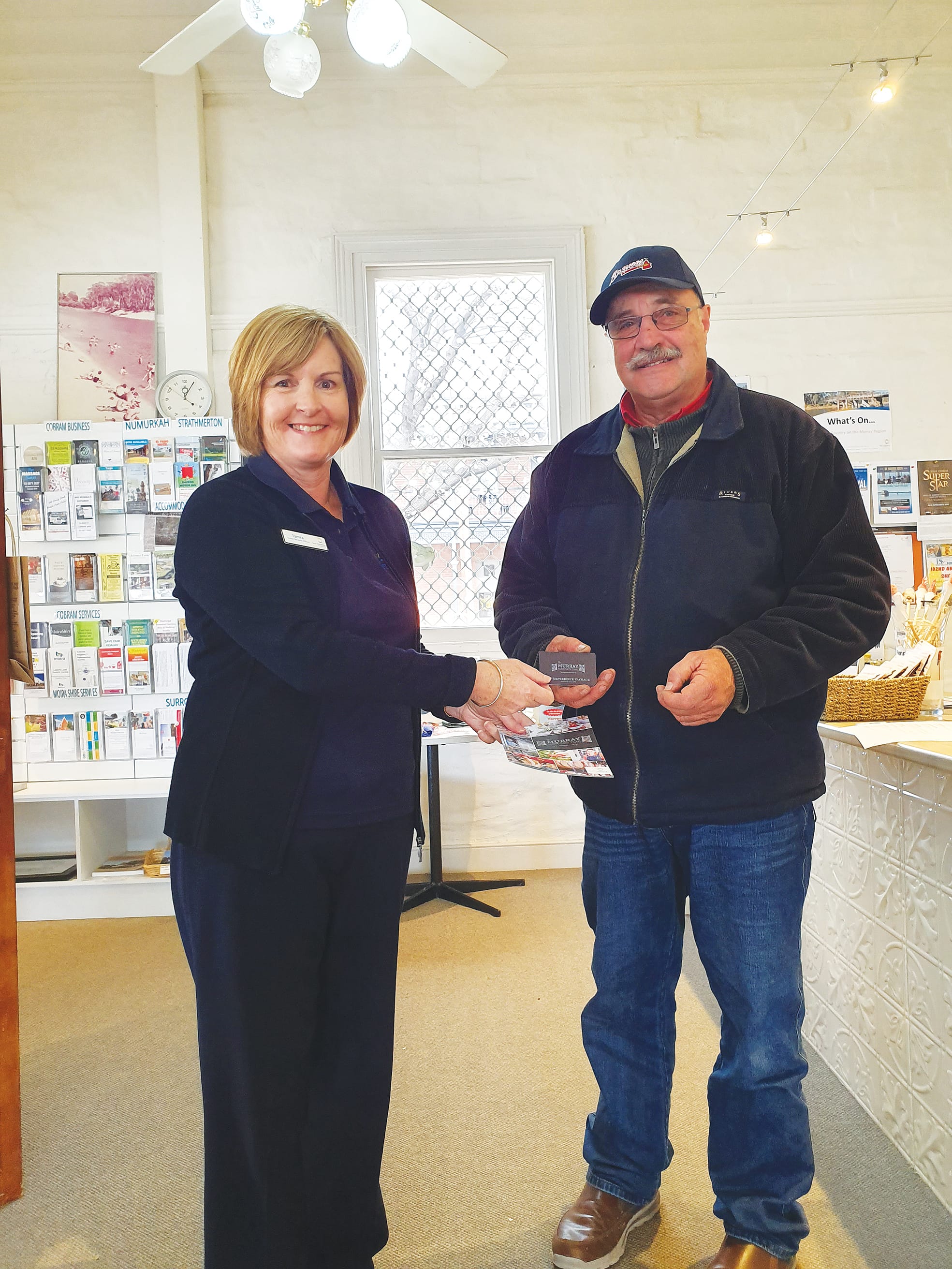 Handing over a great deal ... Moira Shire Visitor Services team member Tamra Coldwell gives visitor Tim Burggraftt from Gippsland a VIP card to make the most of the farm gate trail.