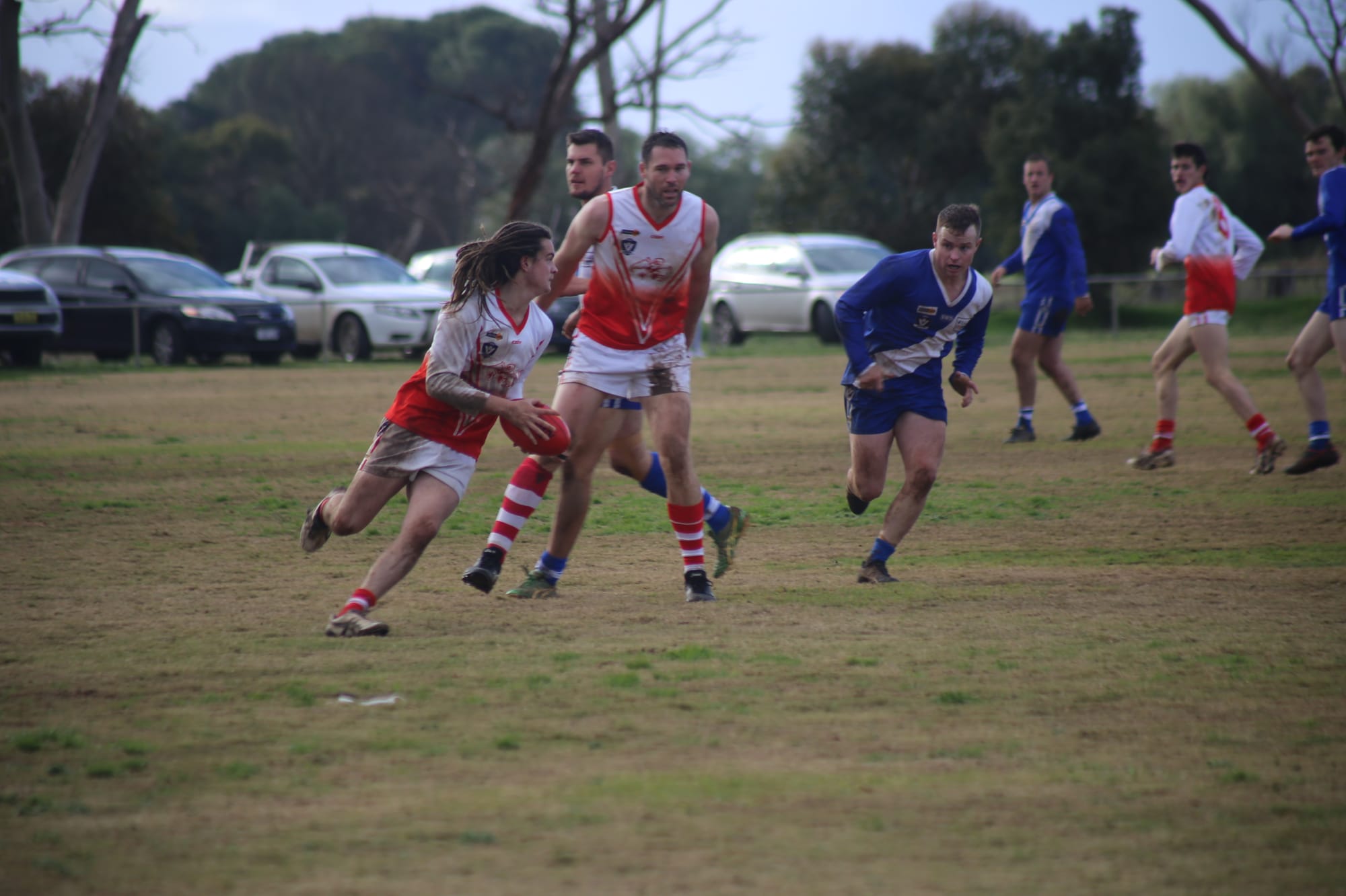 Looking for an option ... Lachlan Daniel carries the ball as Mitch Sidebottom shepherds.
