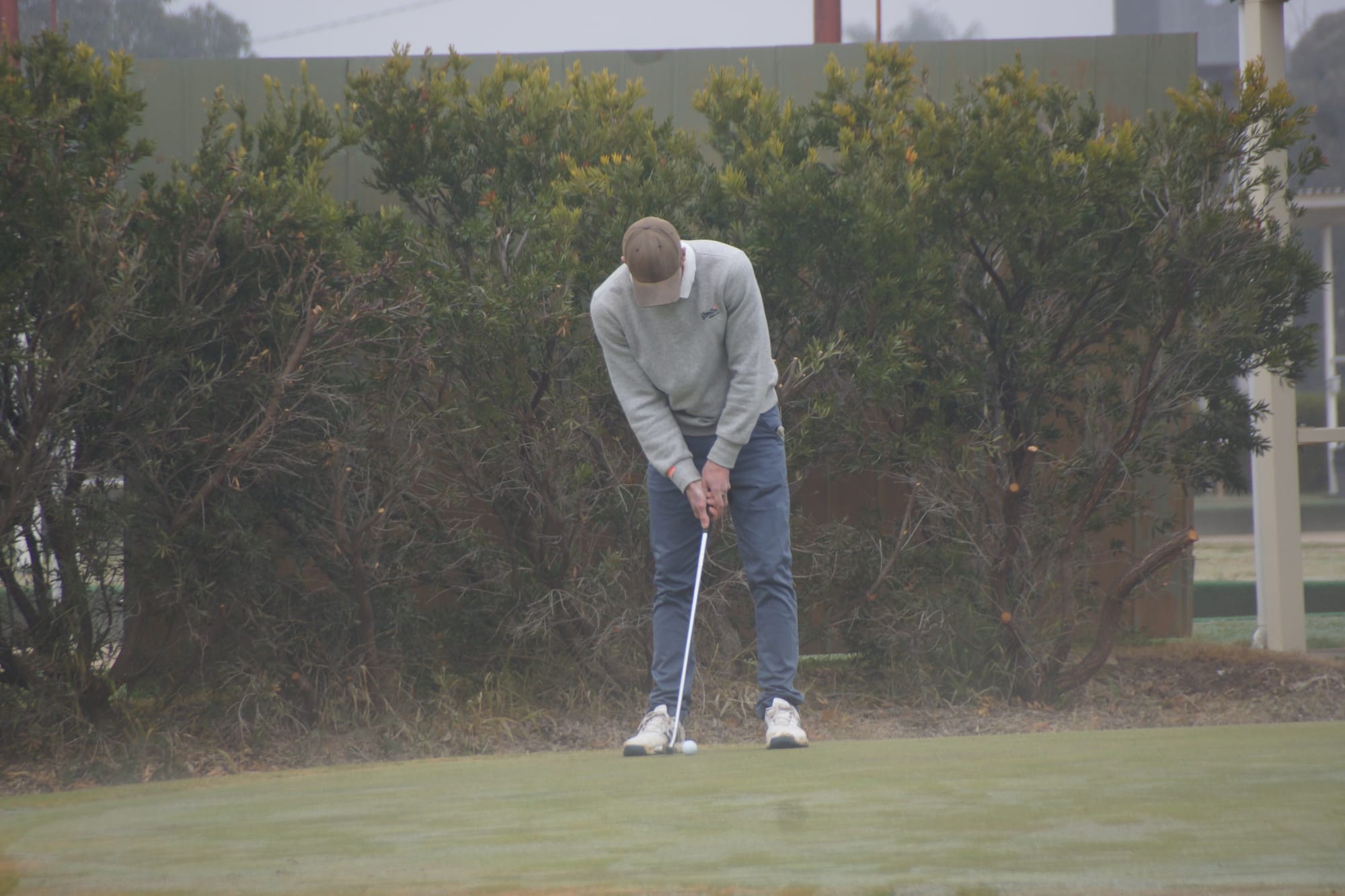 Lone raider ... Scott Hutchins on the putting greenbefore Saturday’s round in the fog, after winning Thursday’s competition.