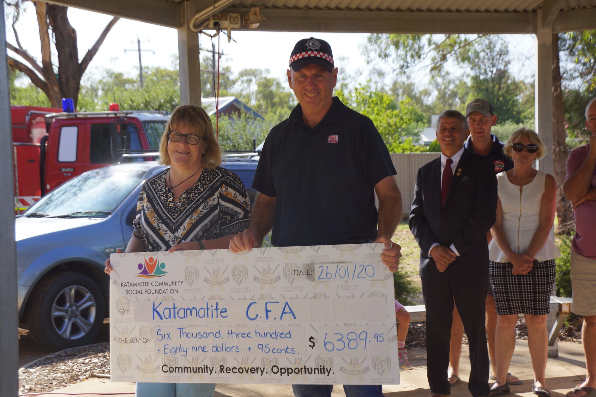 Generosity ... CFA captain John Parnell accepts a cheque from Katamatite Community Action Group secretary June Wood at Sunday’s Australia Day ceremony.