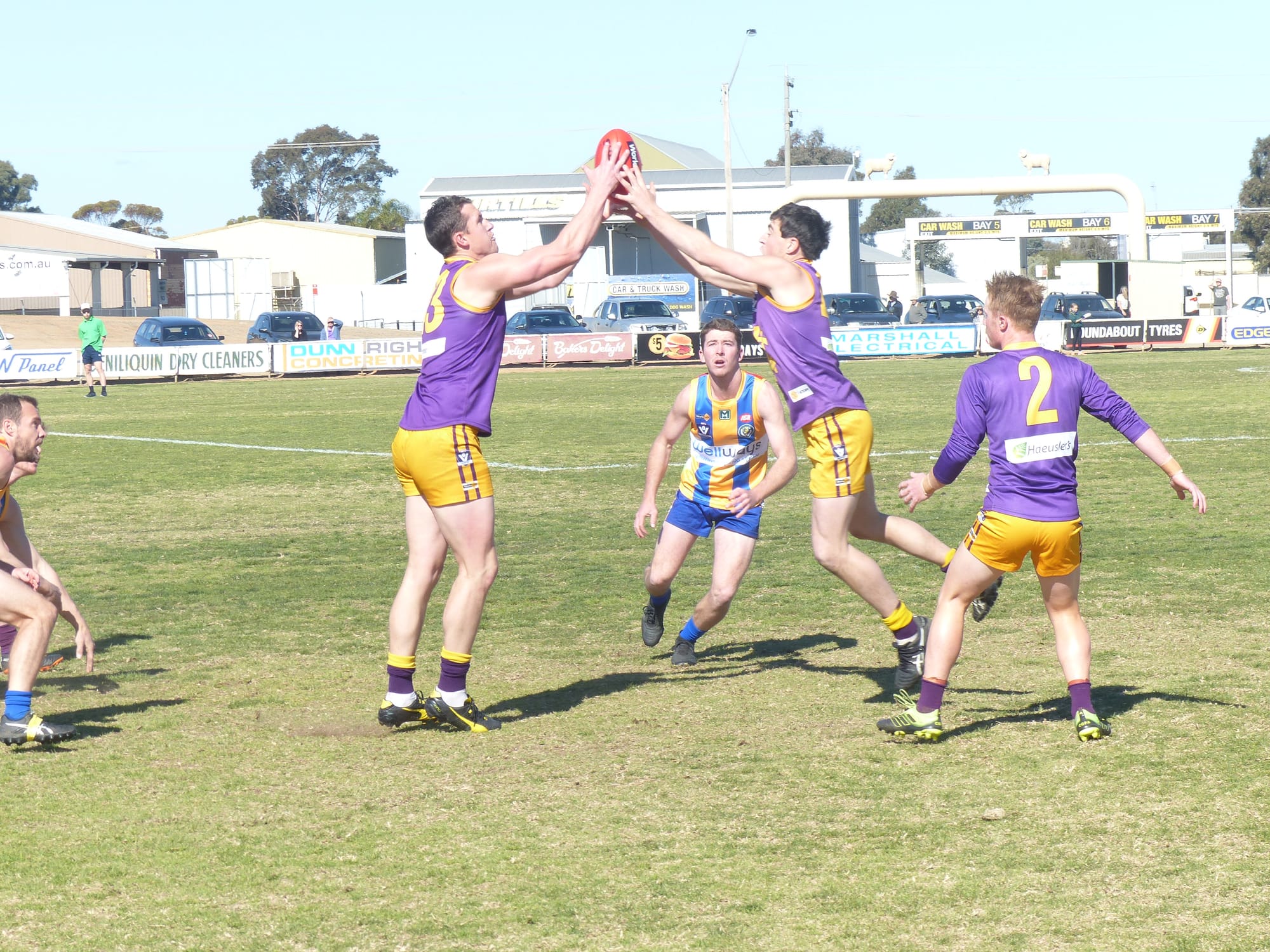 All hands on the ball … Bailey Bell waits for either Mal Barnes or Brodie Ross to deliver the ball.