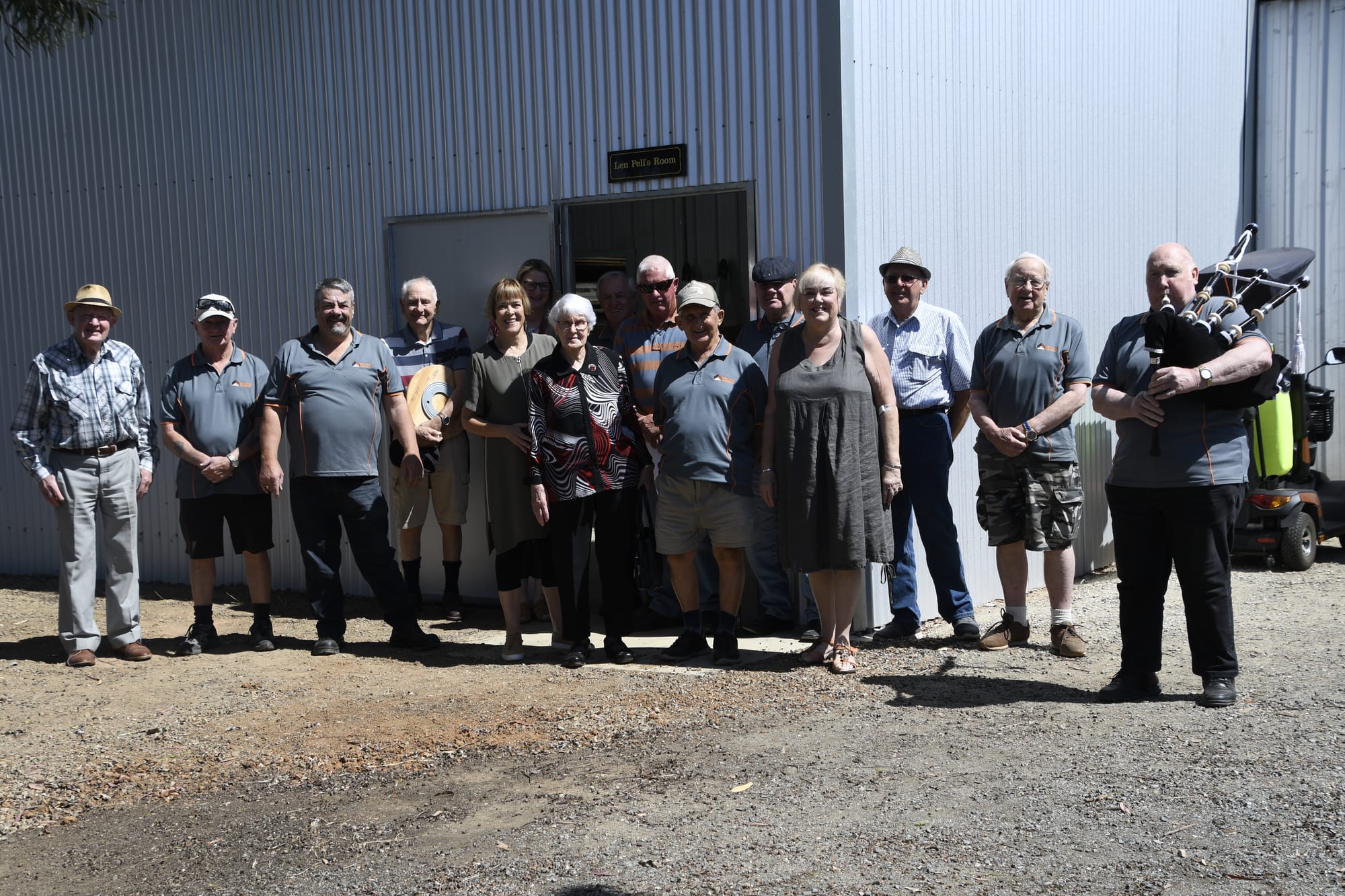 Open for business ... Men’s Shed members and committee members celebrate the opening of the extension with Margaret Pell, Bendigo Community Bank’s Julia Arho and Cr Marie Martin. 