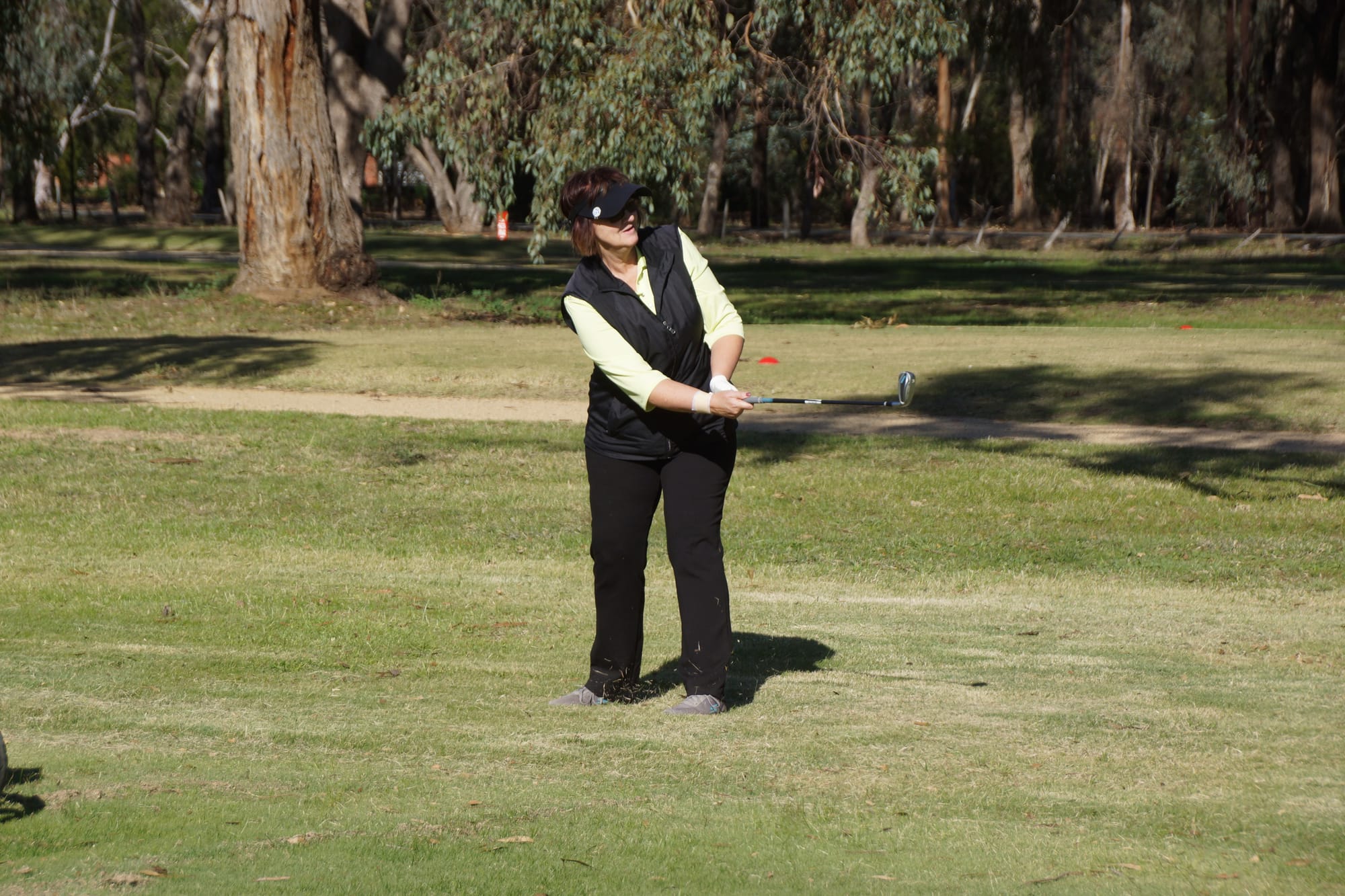 Unwedged ... Jenny Ludington watches her chip onto the green.