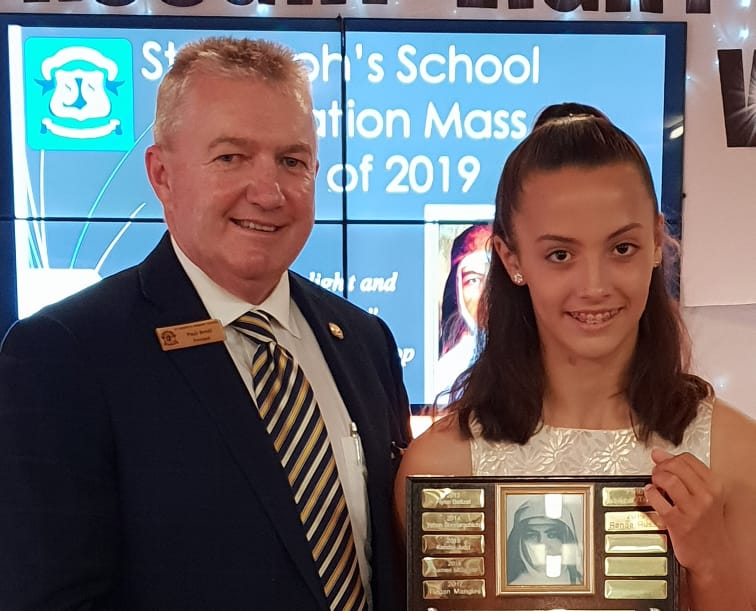 Highest award ... St Joe’s principal Paul Arnel presents Renae Russo with the school’s prestigious Mary MacKillop award.