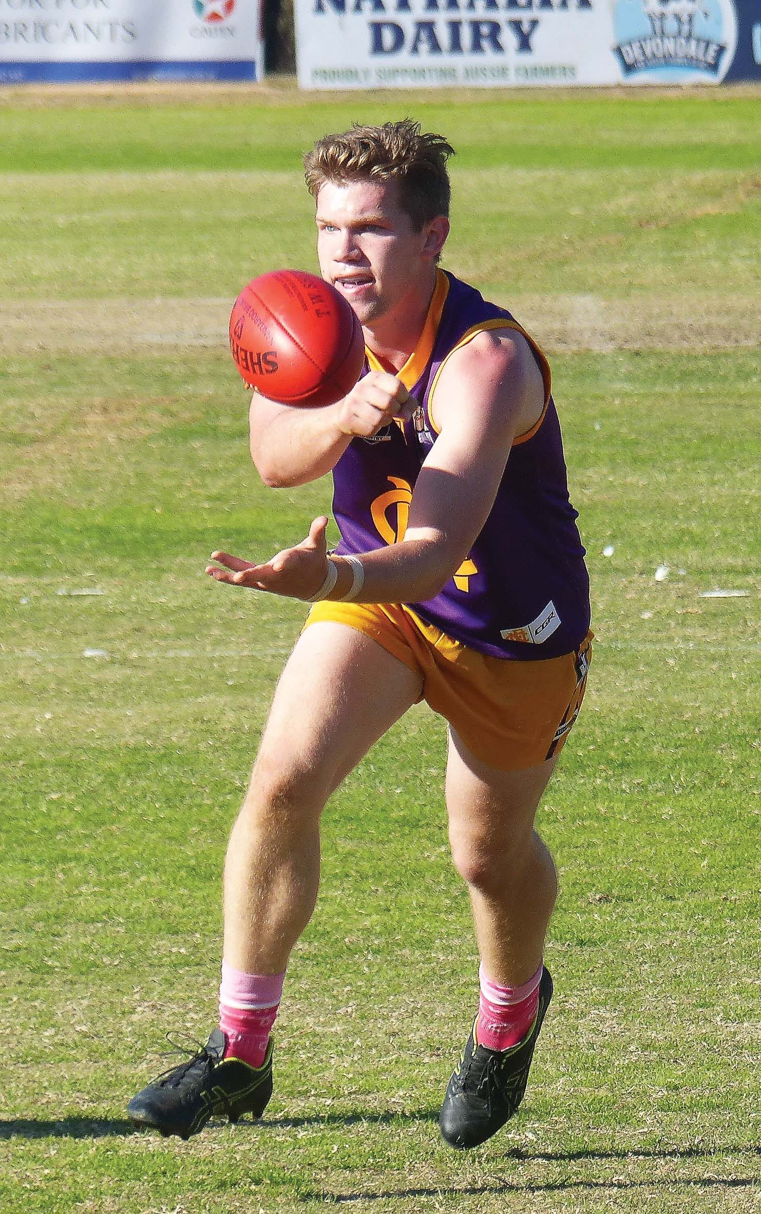Quick give ... Sean Zammit handballs it off to a teammate. 

