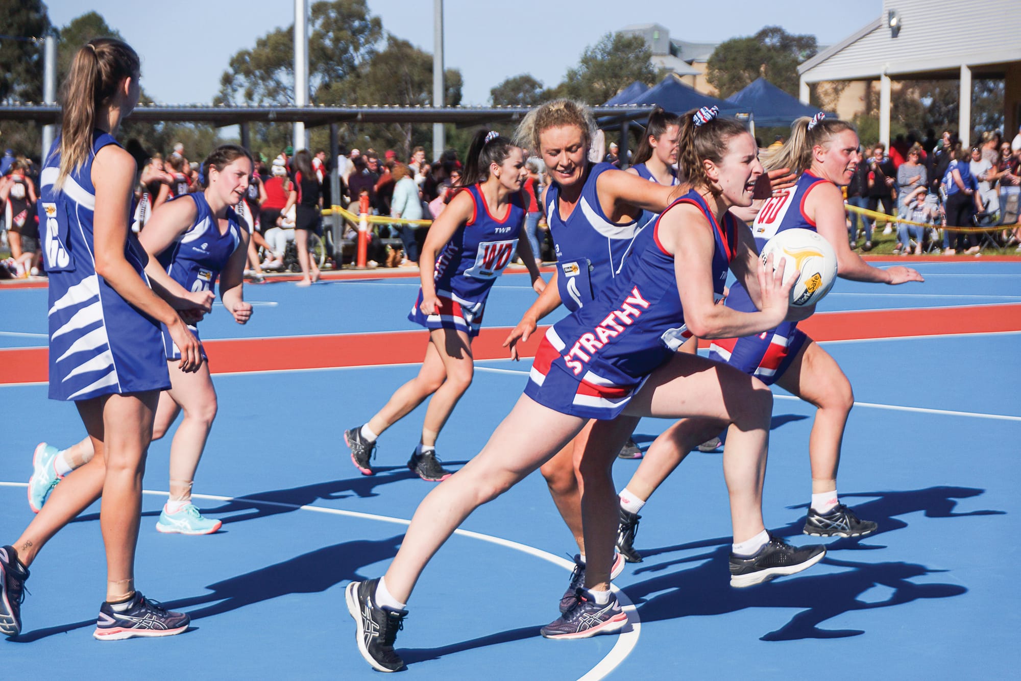 Pass away … Best on court, Strathmerton goalkeeper Tegan Sutton gets the ball away from goal, under pressure from Picola’s Demi Morrison.