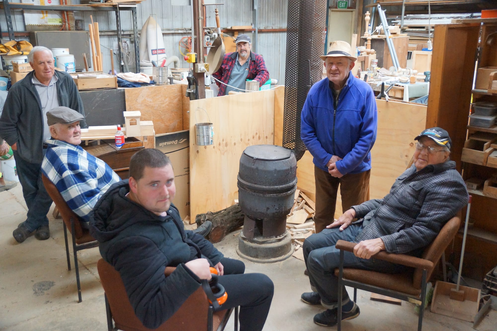 Good company by the fire ... Men’s shed members gather around the fire for a yarn - at a safe distance. 