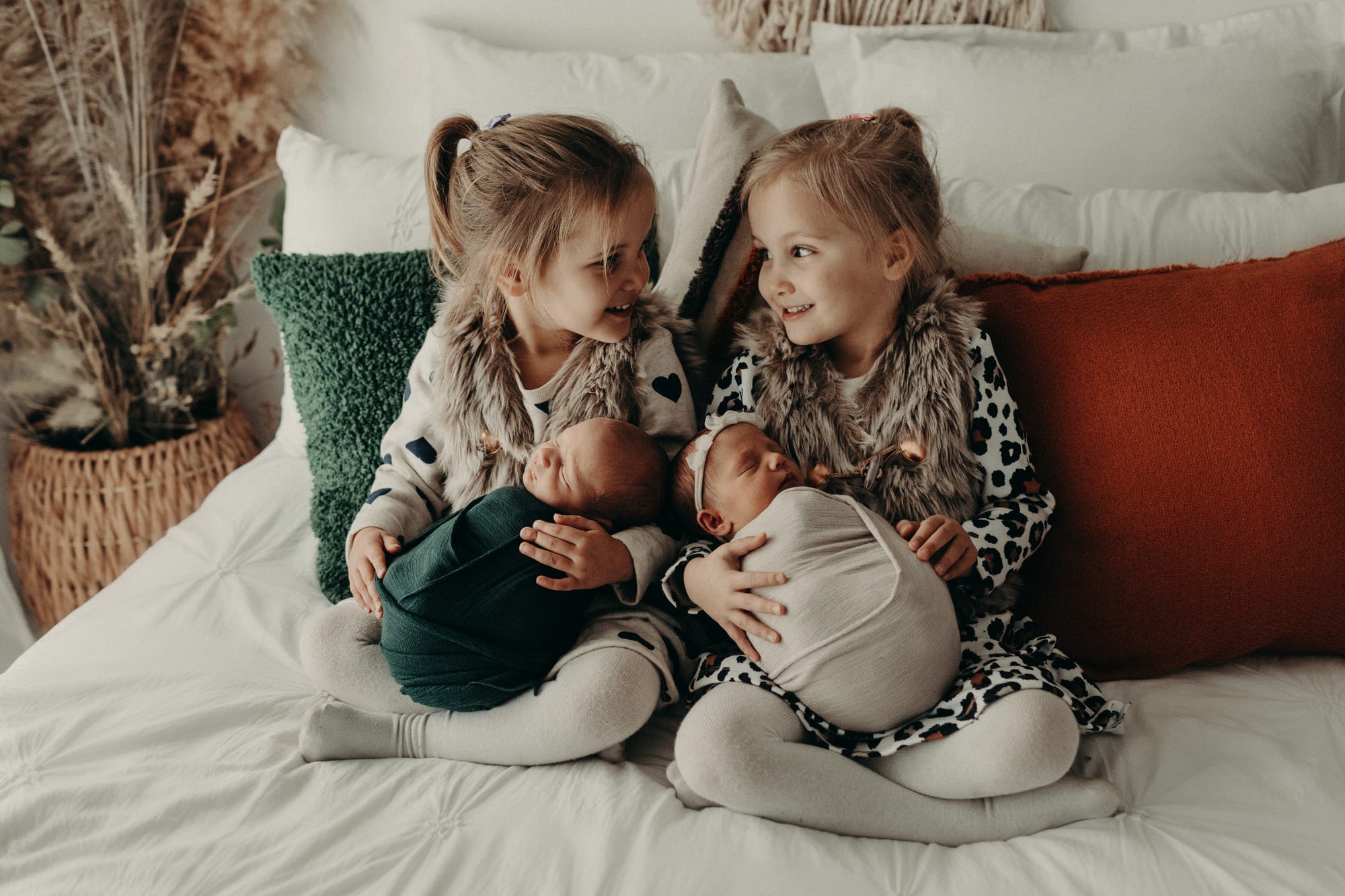 Absolutely adorable ... Proud big sisters Sophie and April Caccianiga cuddle their new siblings Samuel and Brooke. Photo: Polly Wright.