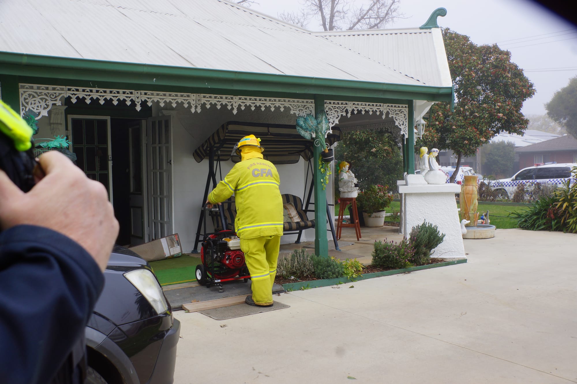 Clearing the smoke ... Numurkah fire fighters used their ventilator fan to clear the home of smoke while they checked for hot spots. 